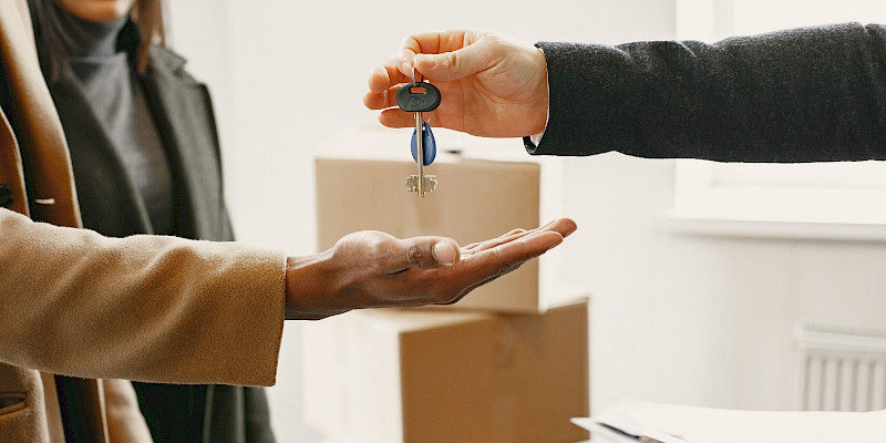 A new homeowner receives keys inside their new home